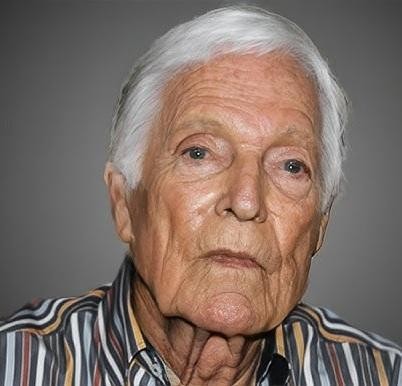 Richard Chamberlain malujący obraz, ukazany w skupieniu, z pędzlem w dłoni, symbolizujący jego pasję do malarstwa.